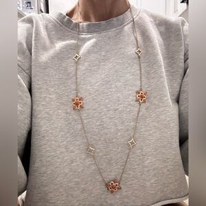 Elegant Long Gold Necklace with Red and Salmon Details